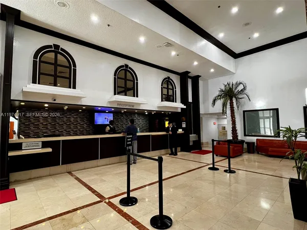 a lobby with furniture and potted plants