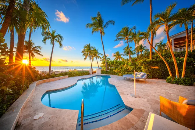 a kitchen with granite countertop stainless steel appliances a sink stove and cabinets
