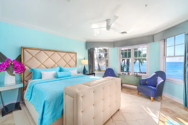 a roof deck with table and chairs with wooden floor