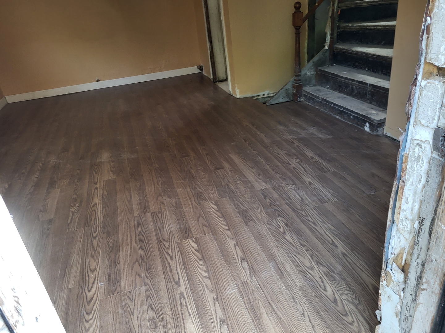911 West Marquette Road Chicago, IL 60621 - Photo 13 of 13 a view of an empty room with wooden floor and stairs