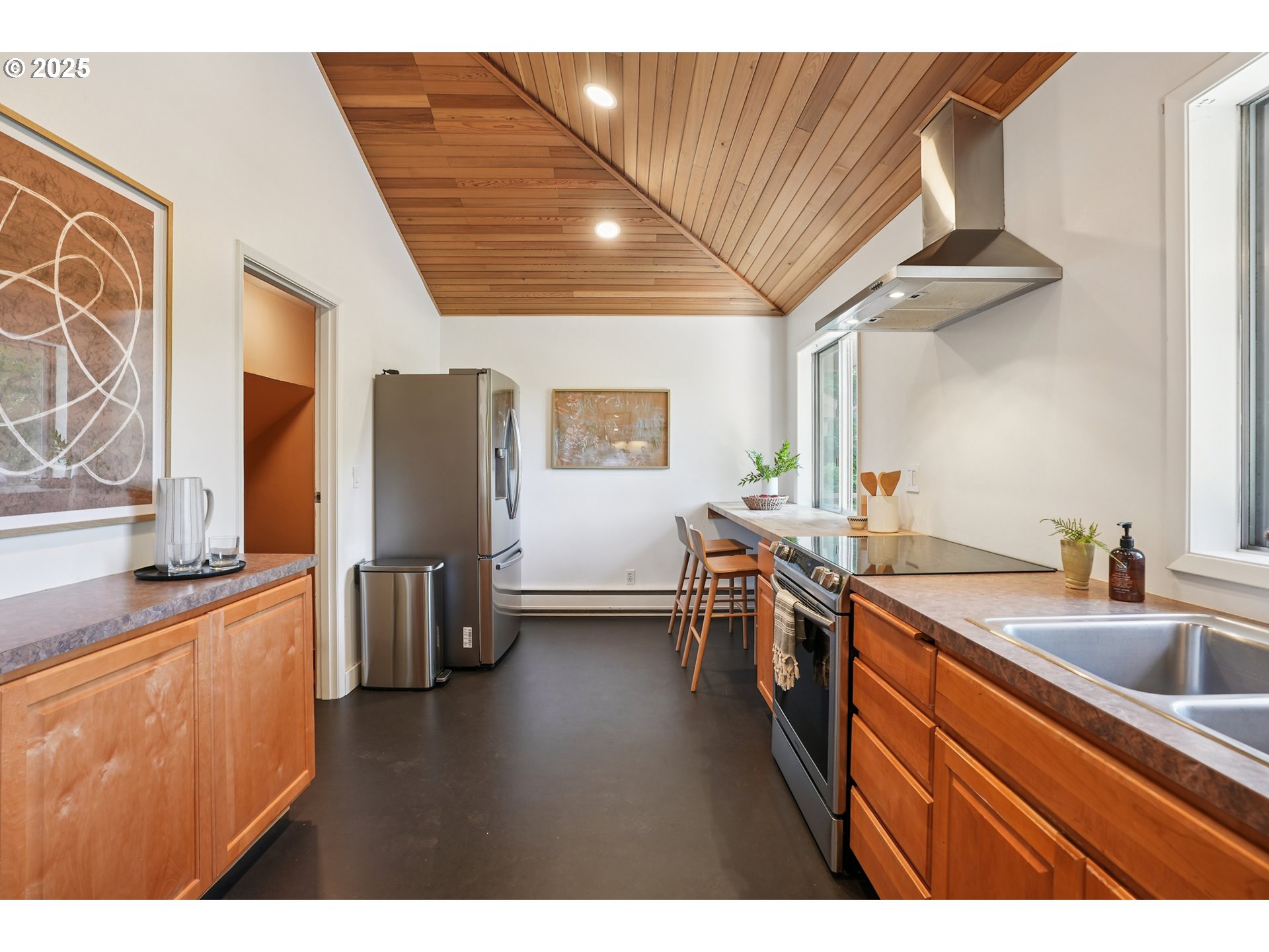 5820 Southwest Miles Court Portland, OR 97219 - Photo 15 of 48 a kitchen with stainless steel appliances granite countertop a sink stove and refrigerator