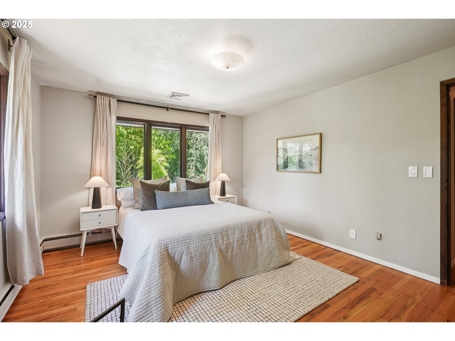 5820 Southwest Miles Court Portland, OR 97219 - Photo 19 of 48 a bedroom with a bed and a wooden floor