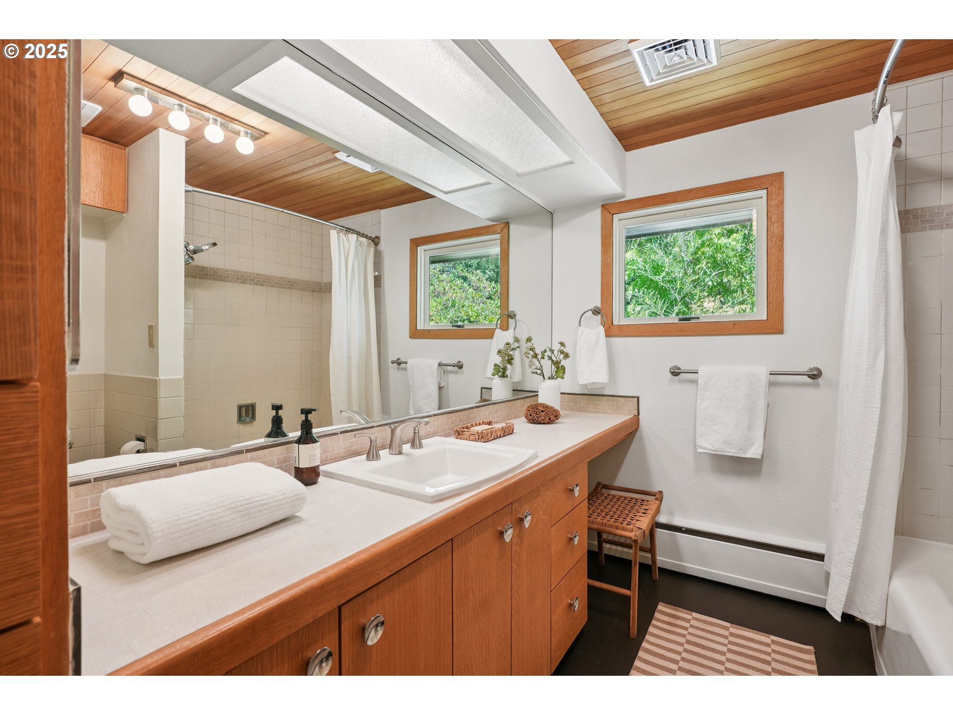 5820 Southwest Miles Court Portland, OR 97219 - Photo 22 of 48 a bathroom with a sink and a mirror