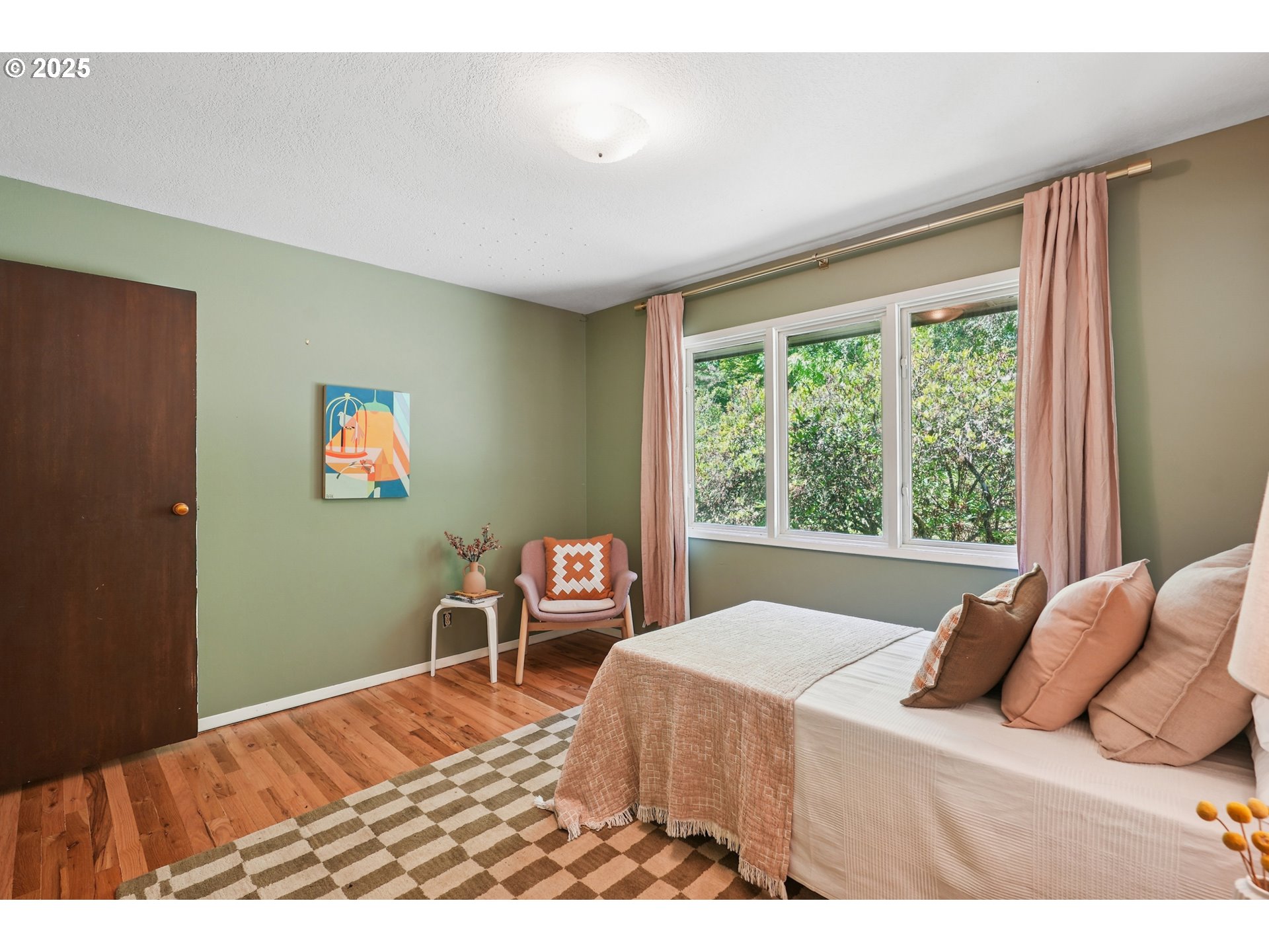 5820 Southwest Miles Court Portland, OR 97219 - Photo 24 of 48 a bedroom with a bed and wooden floor