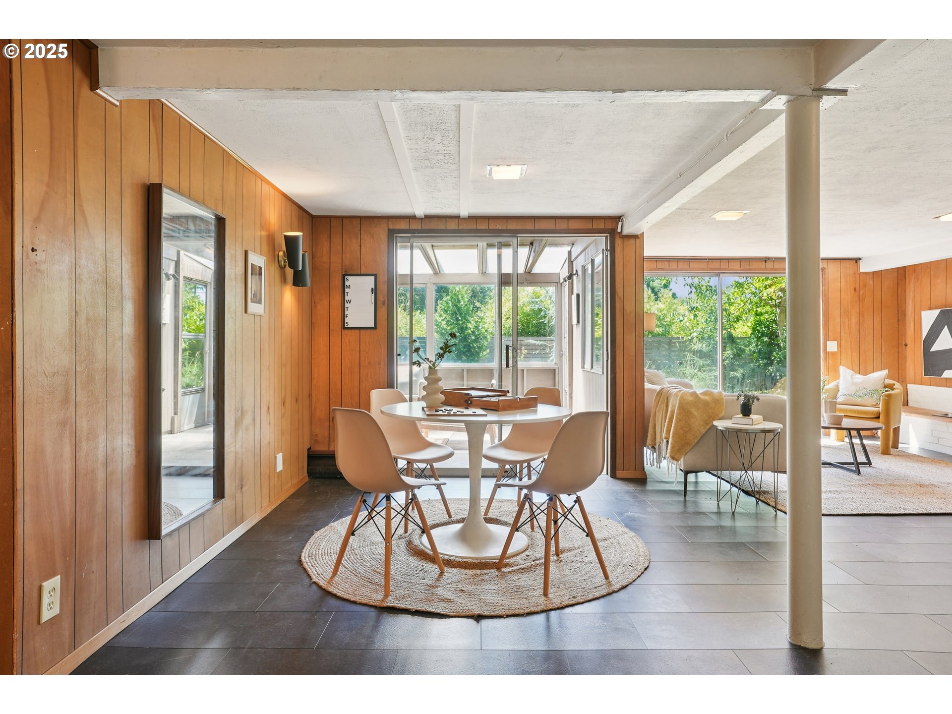 5820 Southwest Miles Court Portland, OR 97219 - Photo 29 of 48 a dining room with wooden floor and a floor to ceiling window