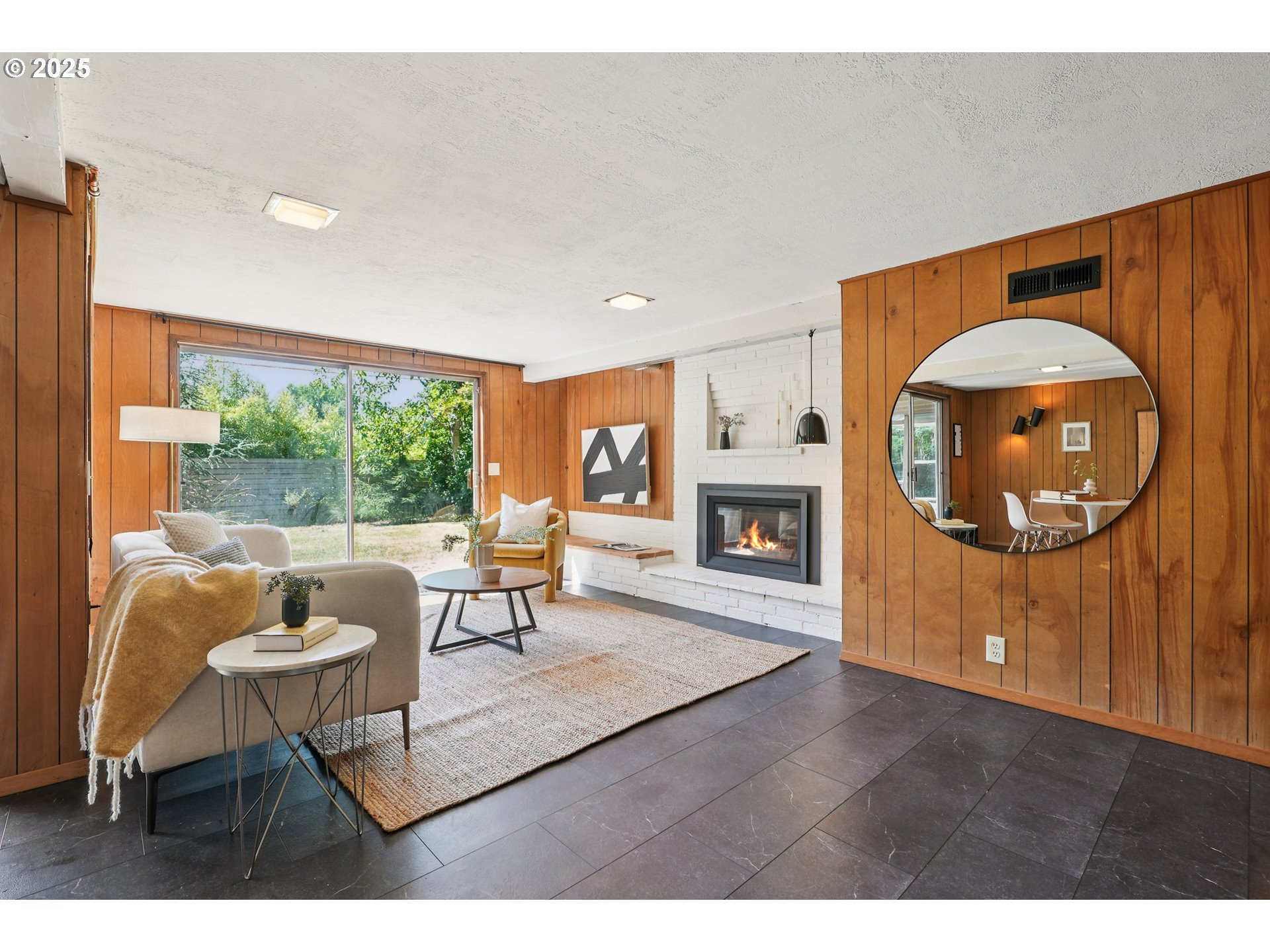 5820 Southwest Miles Court Portland, OR 97219 - Photo 30 of 48 a living room with furniture a window and a fireplace