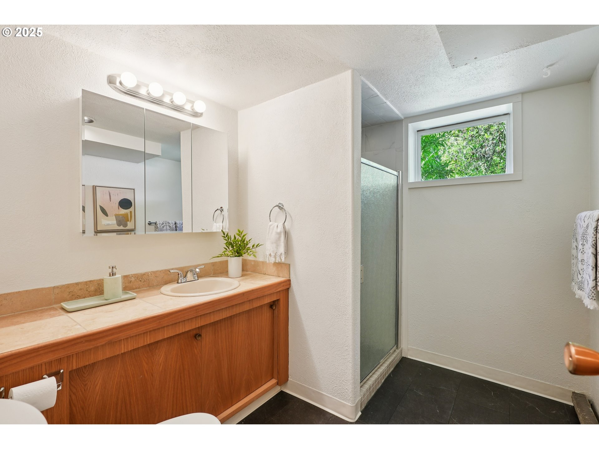 5820 Southwest Miles Court Portland, OR 97219 - Photo 35 of 48 a bathroom with a sink and a mirror