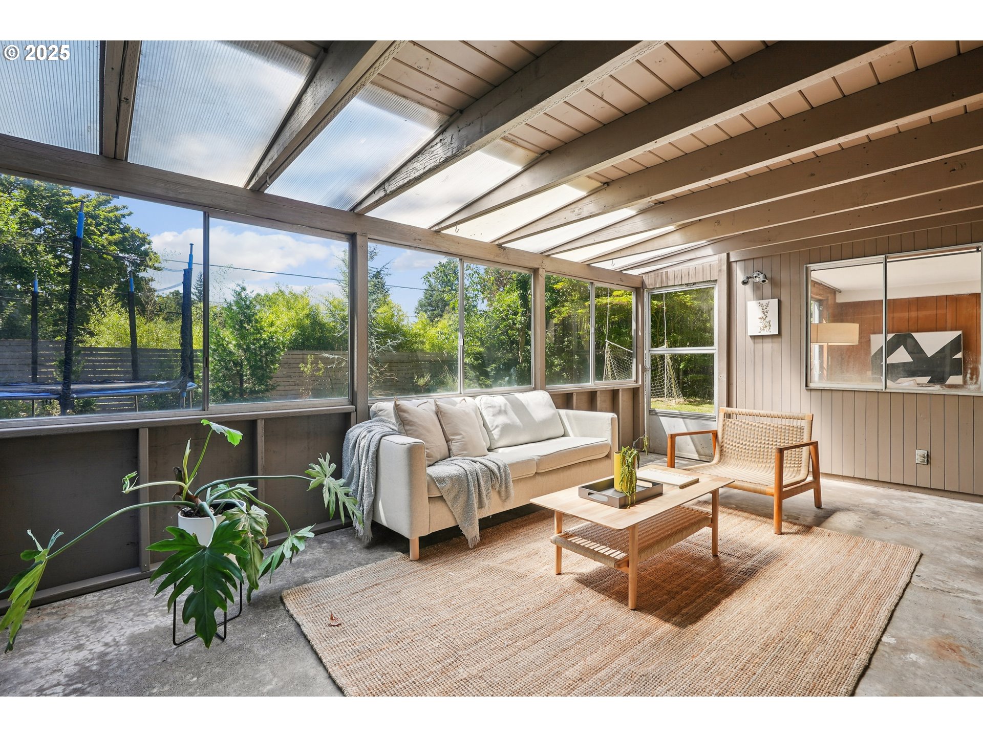 5820 Southwest Miles Court Portland, OR 97219 - Photo 40 of 48 a living room with patio furniture and a potted plant