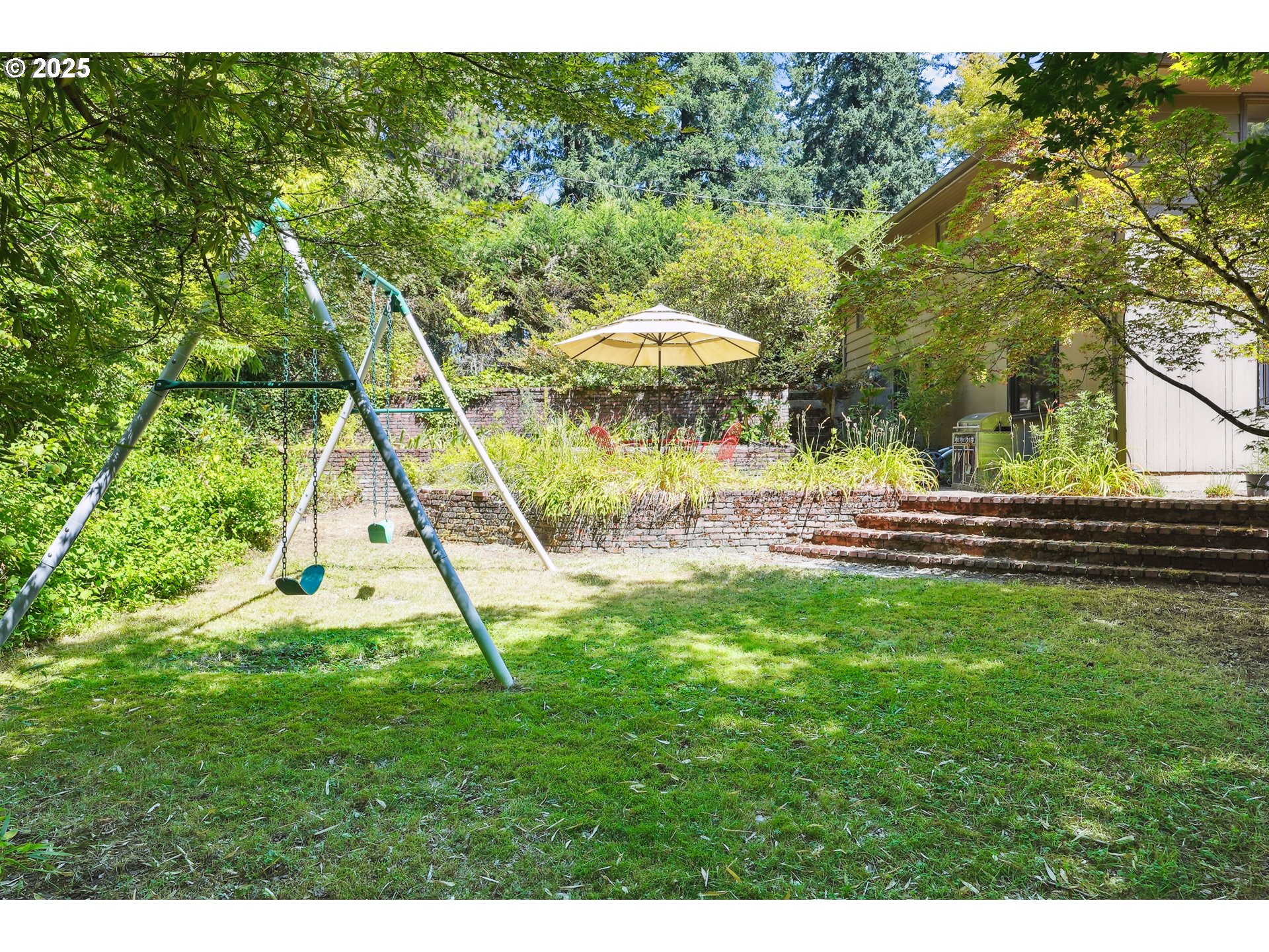 5820 Southwest Miles Court Portland, OR 97219 - Photo 43 of 48 a view of a backyard with a garden and entertaining space