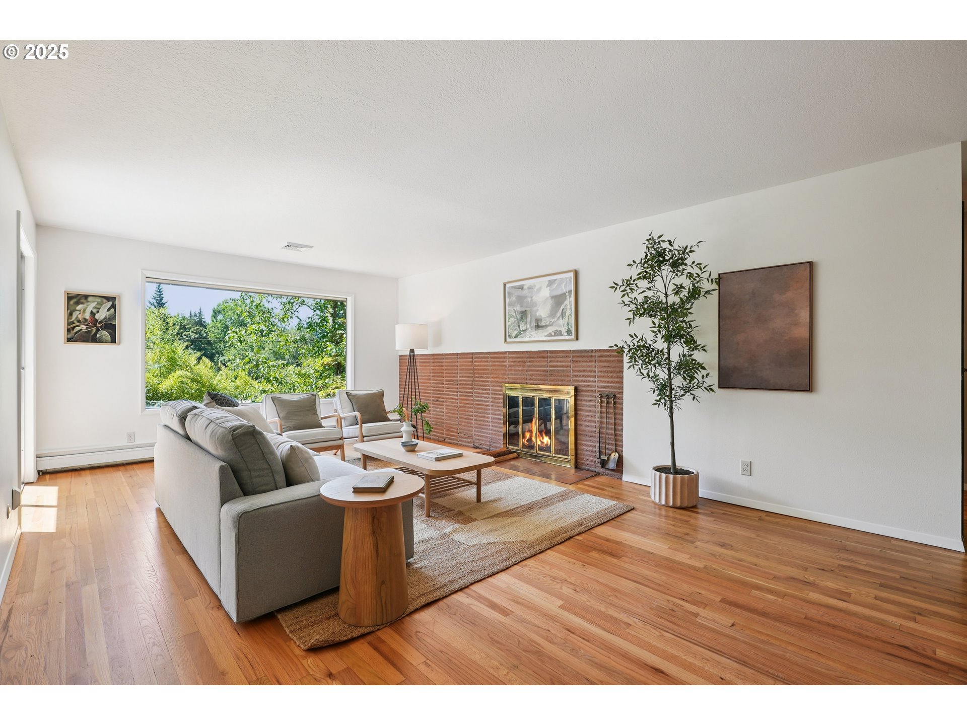 5820 Southwest Miles Court Portland, OR 97219 - Photo 6 of 48 a living room with fireplace furniture and a large window