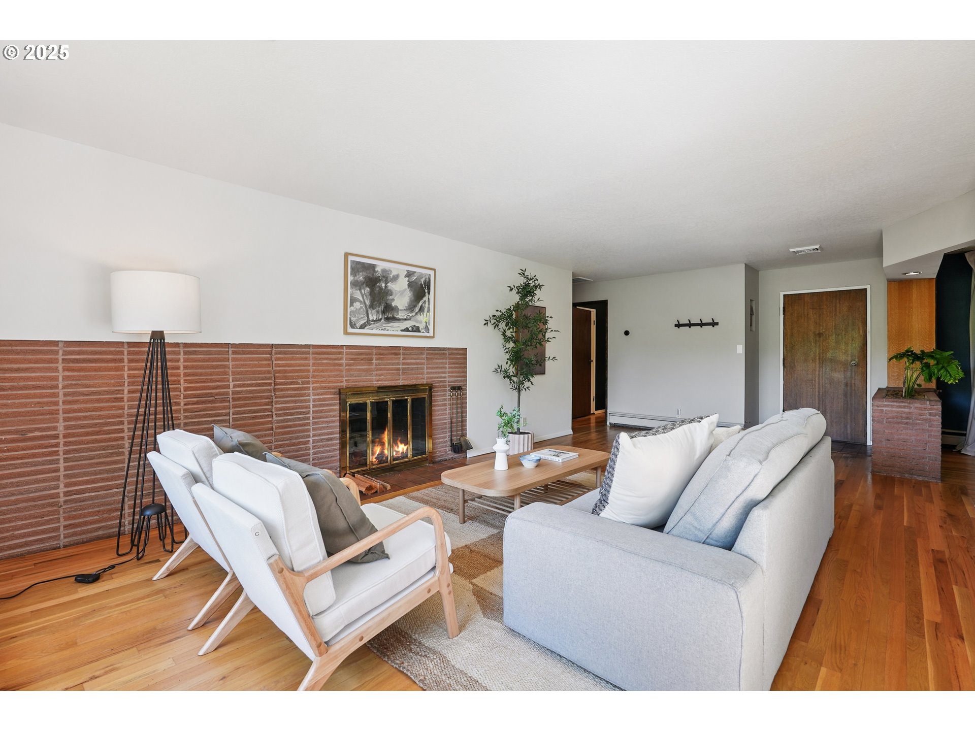 5820 Southwest Miles Court Portland, OR 97219 - Photo 8 of 48 a living room with furniture a fireplace and a table