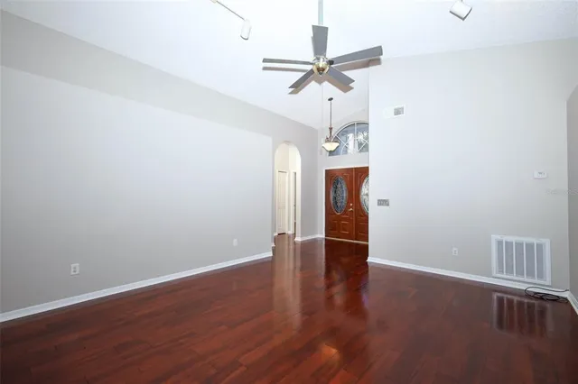 wooden floor in an empty room with a window