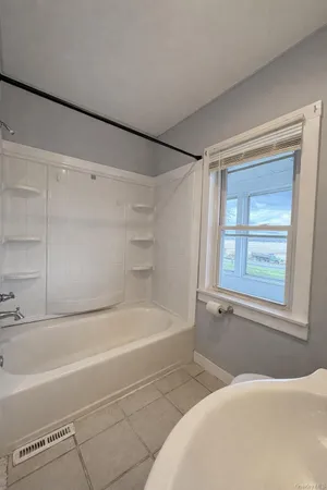 a bathroom with a bathtub and a shower