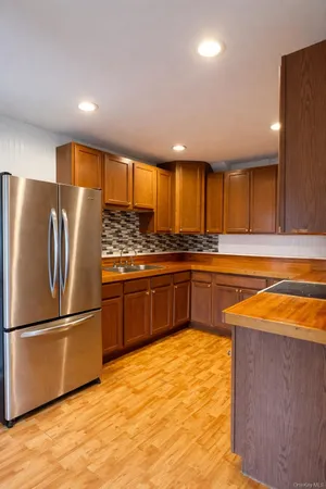 a kitchen with stainless steel appliances granite countertop a refrigerator and a stove top oven