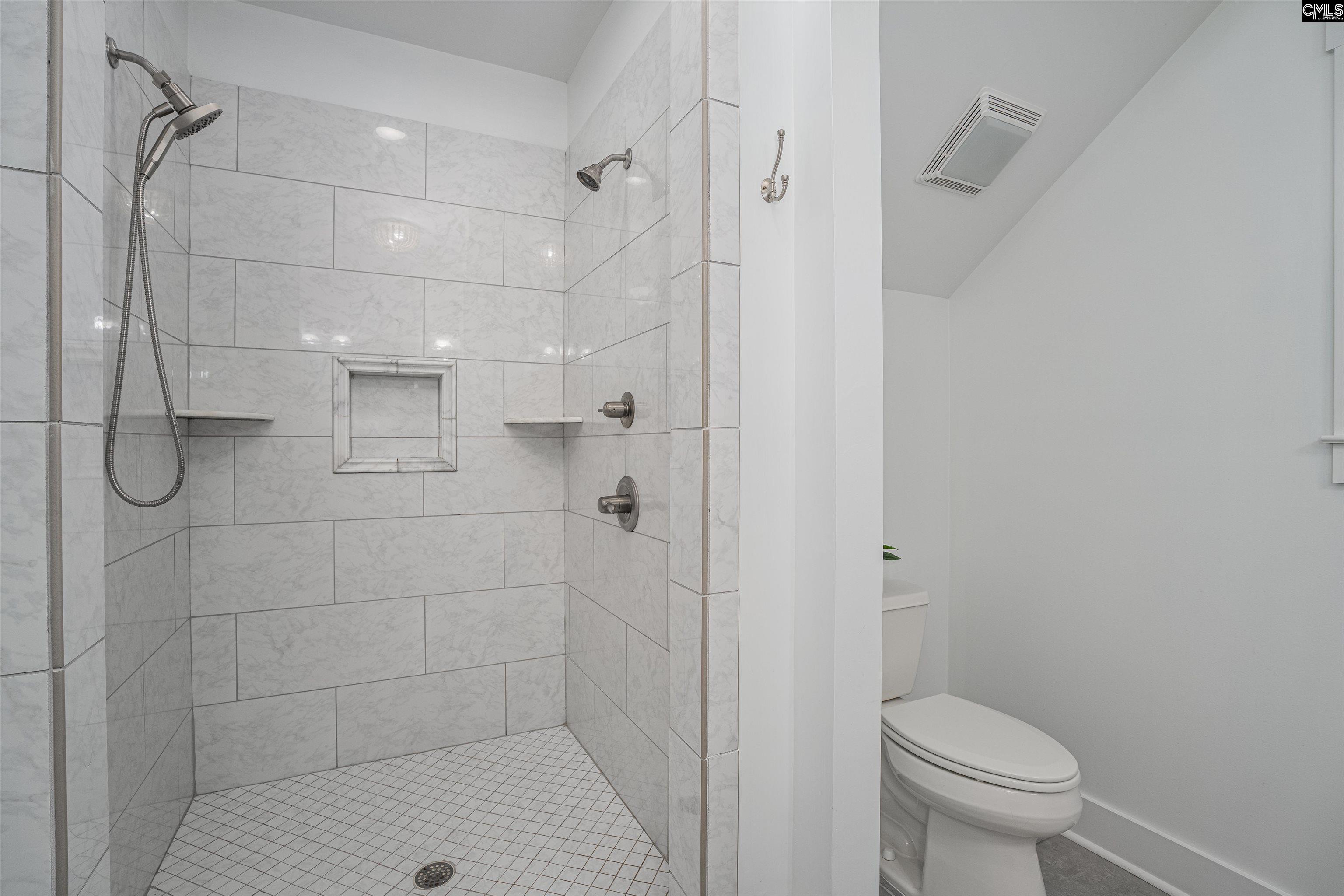 649 Sandbar Road Chapin, SC 29036 - Photo 26 of 40 a bathroom with a shower a toilet and a shower