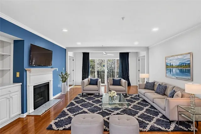 a living room with furniture a fireplace and a flat screen tv