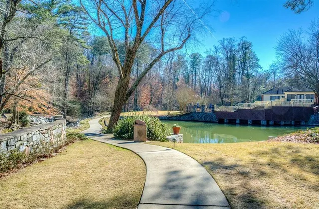 a view of swimming pool with a yard and green space