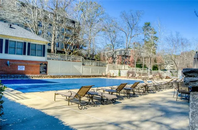 a view of swimming pool with outdoor seating and plants