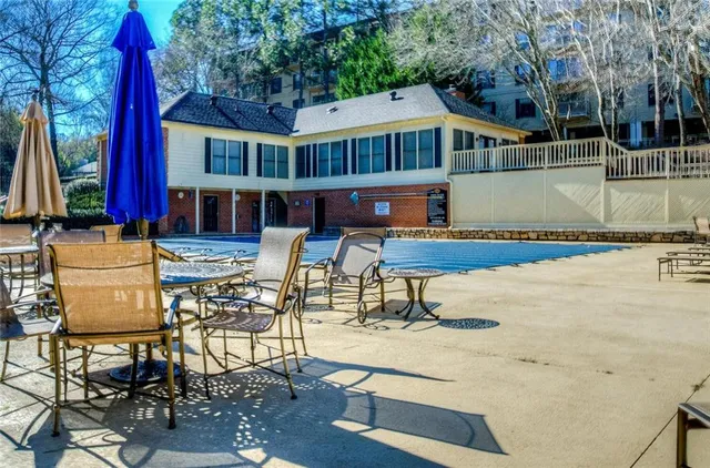 a view of a patio with table and chairs with wooden floor and fence