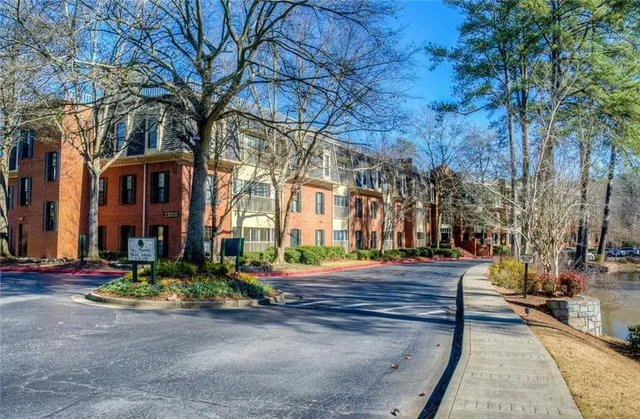 a front view of a building with trees