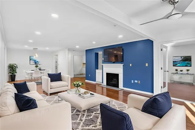 a living room with furniture a fireplace and a view of kitchen