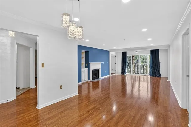a view of livingroom with hardwood floor and kitchen view
