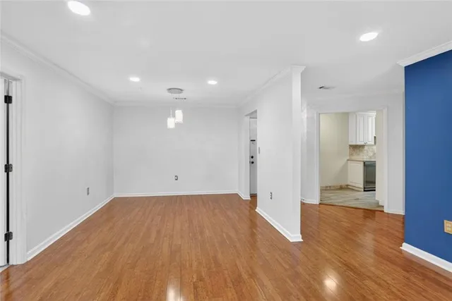 a view of a big room with wooden floor and a bathroom