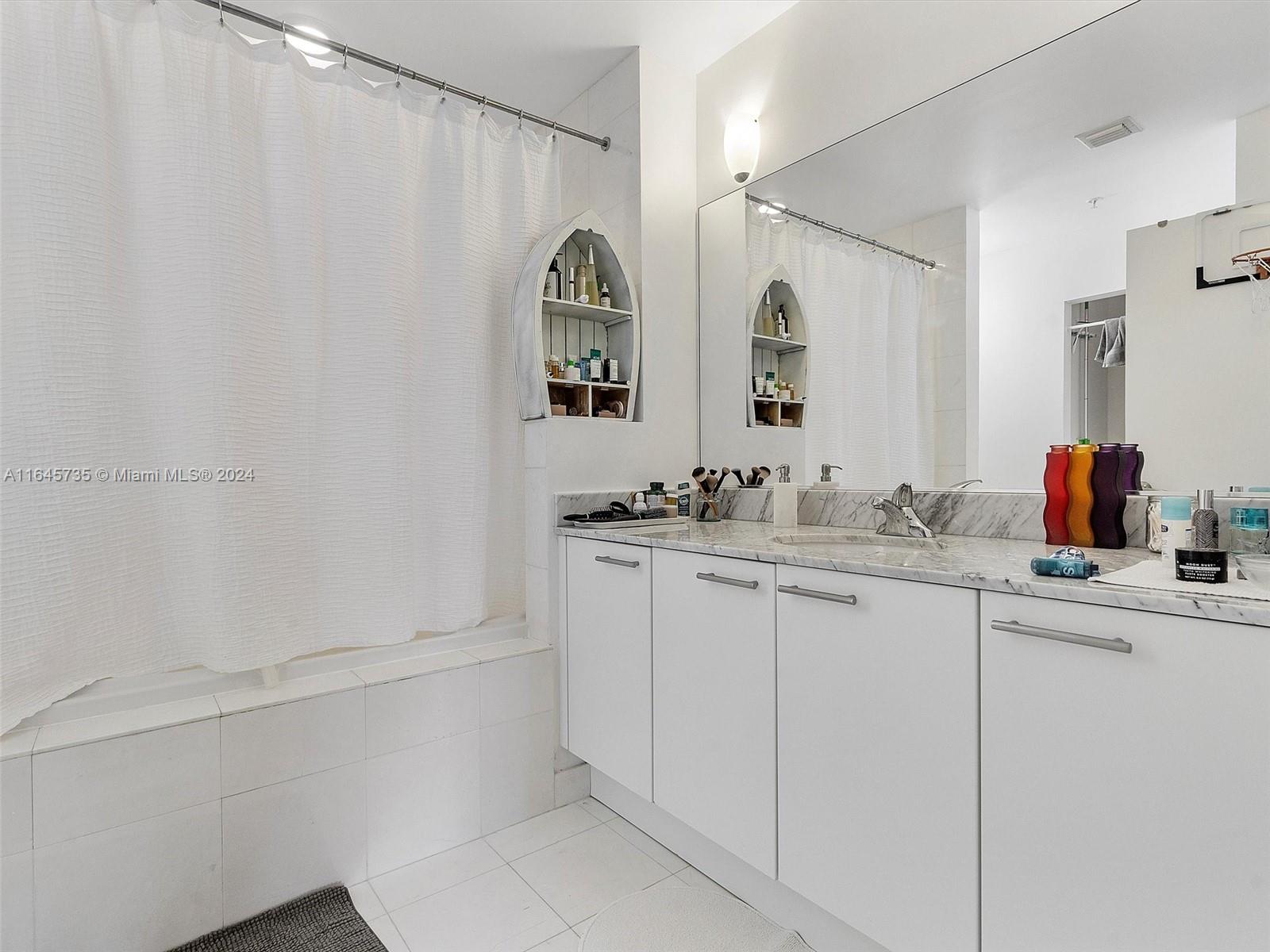 2001 Meridian Avenue, Unit 306 Miami Beach, FL 33139 - Photo 12 of 17 a bathroom with a sink and a mirror