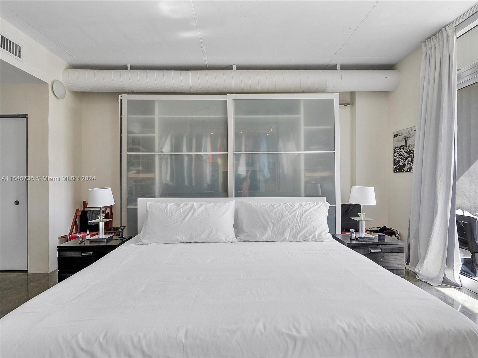 2001 Meridian Avenue, Unit 306 Miami Beach, FL 33139 - Photo 7 of 17 a bedroom with a large bed and a large window