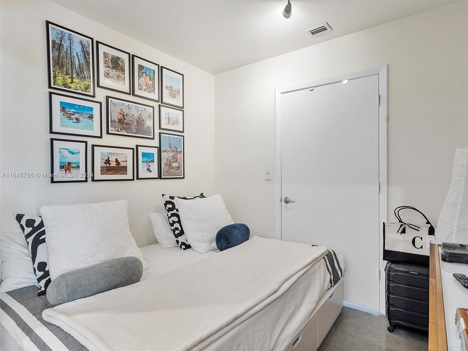 2001 Meridian Avenue, Unit 306 Miami Beach, FL 33139 - Photo 8 of 17 a bedroom with a bed and a painting on the wall