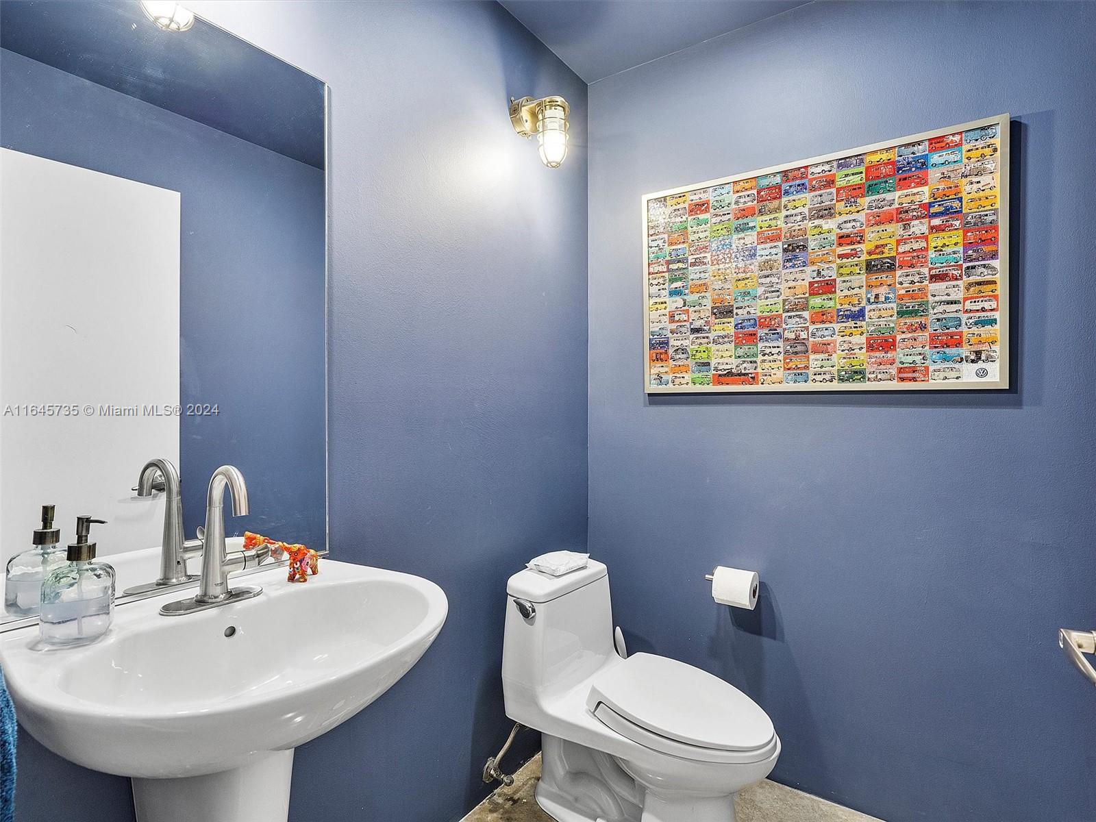 2001 Meridian Avenue, Unit 306 Miami Beach, FL 33139 - Photo 9 of 17 a bathroom with a toilet a sink and a mirror