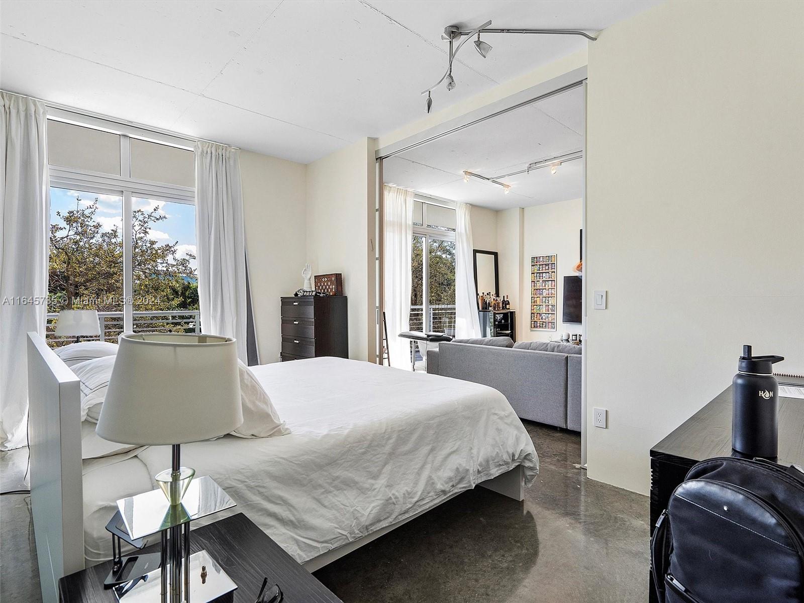 2001 Meridian Avenue, Unit 306 Miami Beach, FL 33139 - Photo 10 of 17 a living room with a bed and large window with outer view