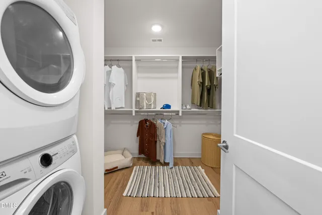a en suite spacious bathroom with a tub double vanity and a mirror