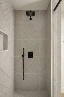 an empty room with a window and a ceiling fan