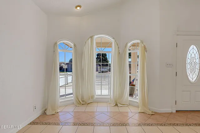 a large kitchen with stainless steel appliances granite countertop a stove and a refrigerator