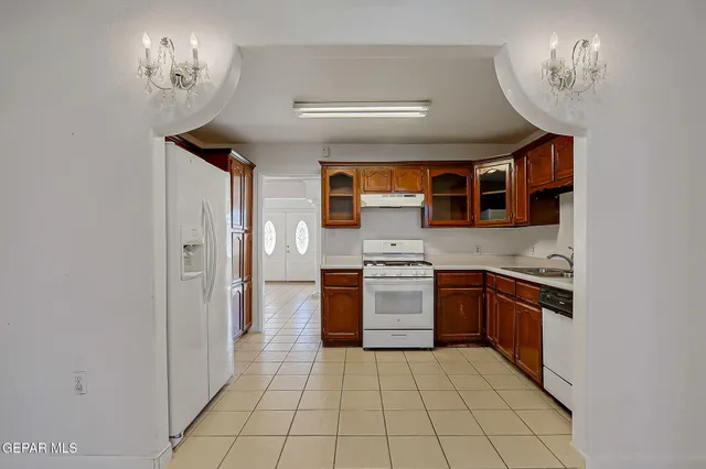 a view of a dining room with furniture a chandelier and wooden floor
