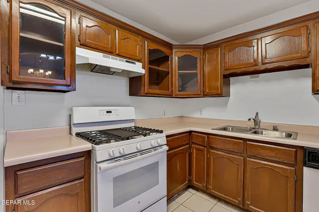 a view of a hallway with wooden floor and chandelier
