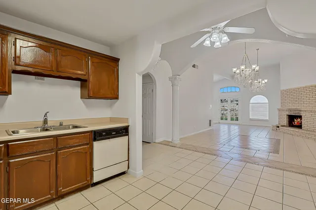 a living room with furniture chandelier and a fireplace