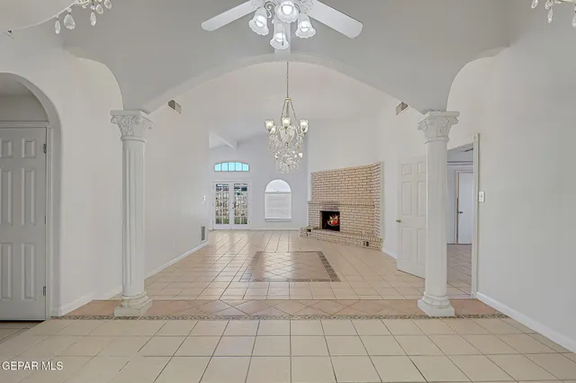 a living room with furniture a flat screen tv and a window