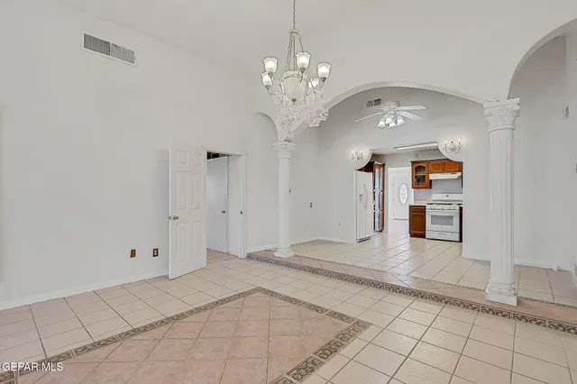 a view of an empty room with a fireplace and a window