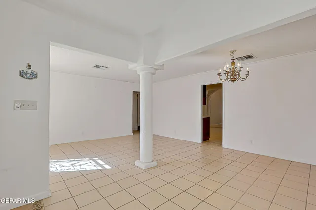 a living room with furniture and entry gate