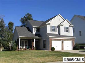 10411 Hellebore Road Charlotte, NC 28213 - Photo 1 of 8 a view of a white house with a big yard and potted plants