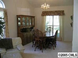 10411 Hellebore Road Charlotte, NC 28213 - Photo 2 of 8 a view of a dining room with furniture and chandelier