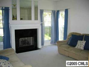 10411 Hellebore Road Charlotte, NC 28213 - Photo 3 of 8 a living room with furniture and a fireplace