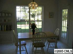 10411 Hellebore Road Charlotte, NC 28213 - Photo 8 of 8 a view of a dining room with furniture and chandelier