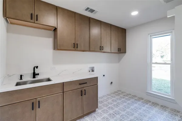 a kitchen with a sink cabinets and window