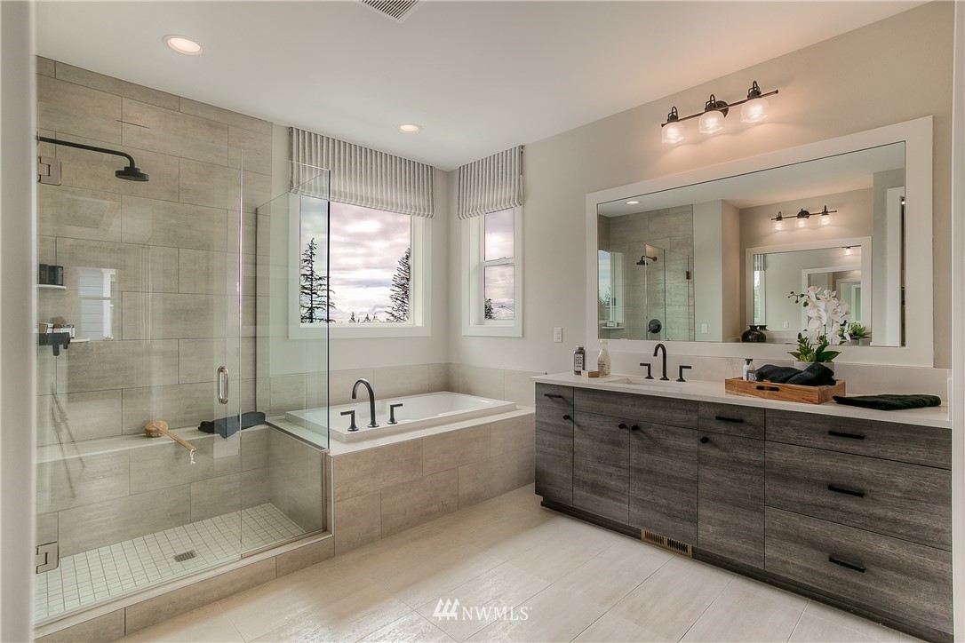 22324 44th Drive Southeast Bothell, WA 98021 - Photo 7 of 11 a bathroom with a tub a sink shower double vanity