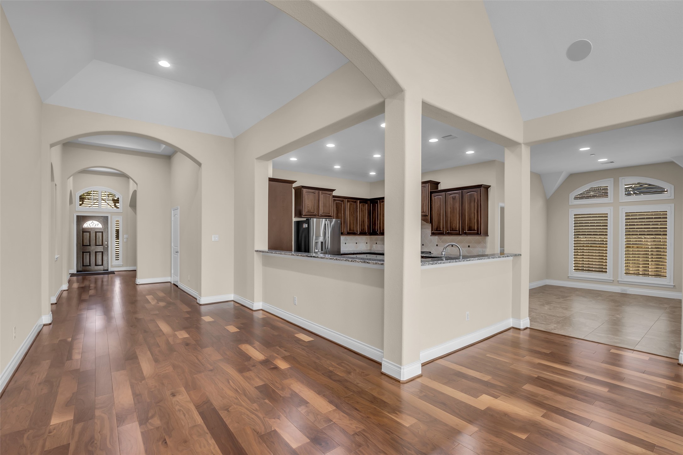 6306 Fisher Bend Lane Rosenberg, TX 77471 - Photo 12 of 26 This wider view of the kitchen shows the entrance on the left and the breakfast nook on the right, highlighting the open layout and easy access to different areas of the home.