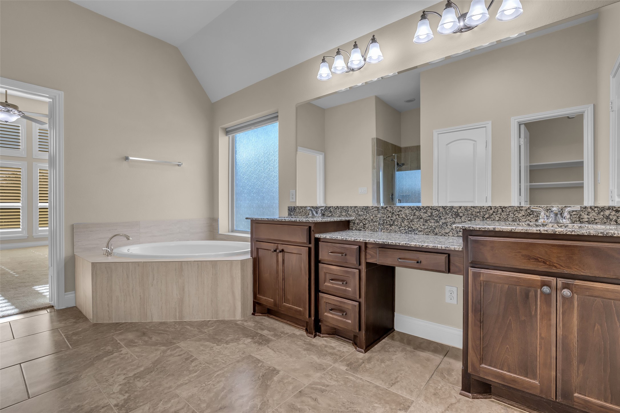 6306 Fisher Bend Lane Rosenberg, TX 77471 - Photo 16 of 26 A different view of the primary bathroom highlights the bathtub area and built-in drawers, adding practical storage and functionality.