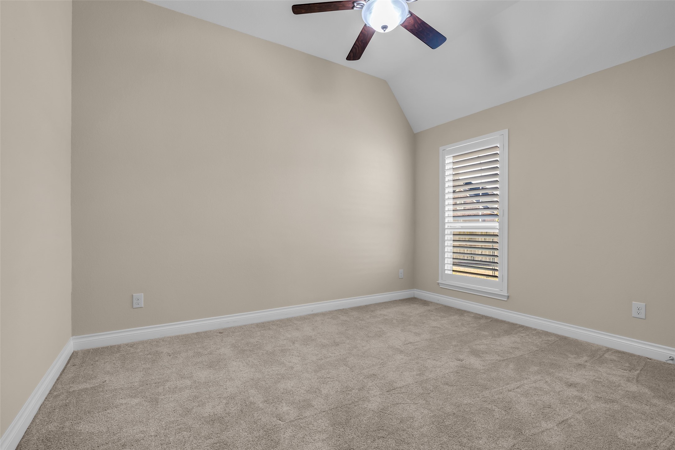 6306 Fisher Bend Lane Rosenberg, TX 77471 - Photo 18 of 26 Another secondary bedroom mirrors the features of the previous one, with carpeted flooring and windows that bring in natural light.